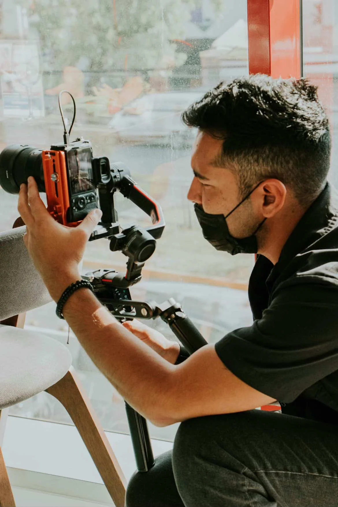 Professional investigator using a camera for surveillance and evidence recording indoors